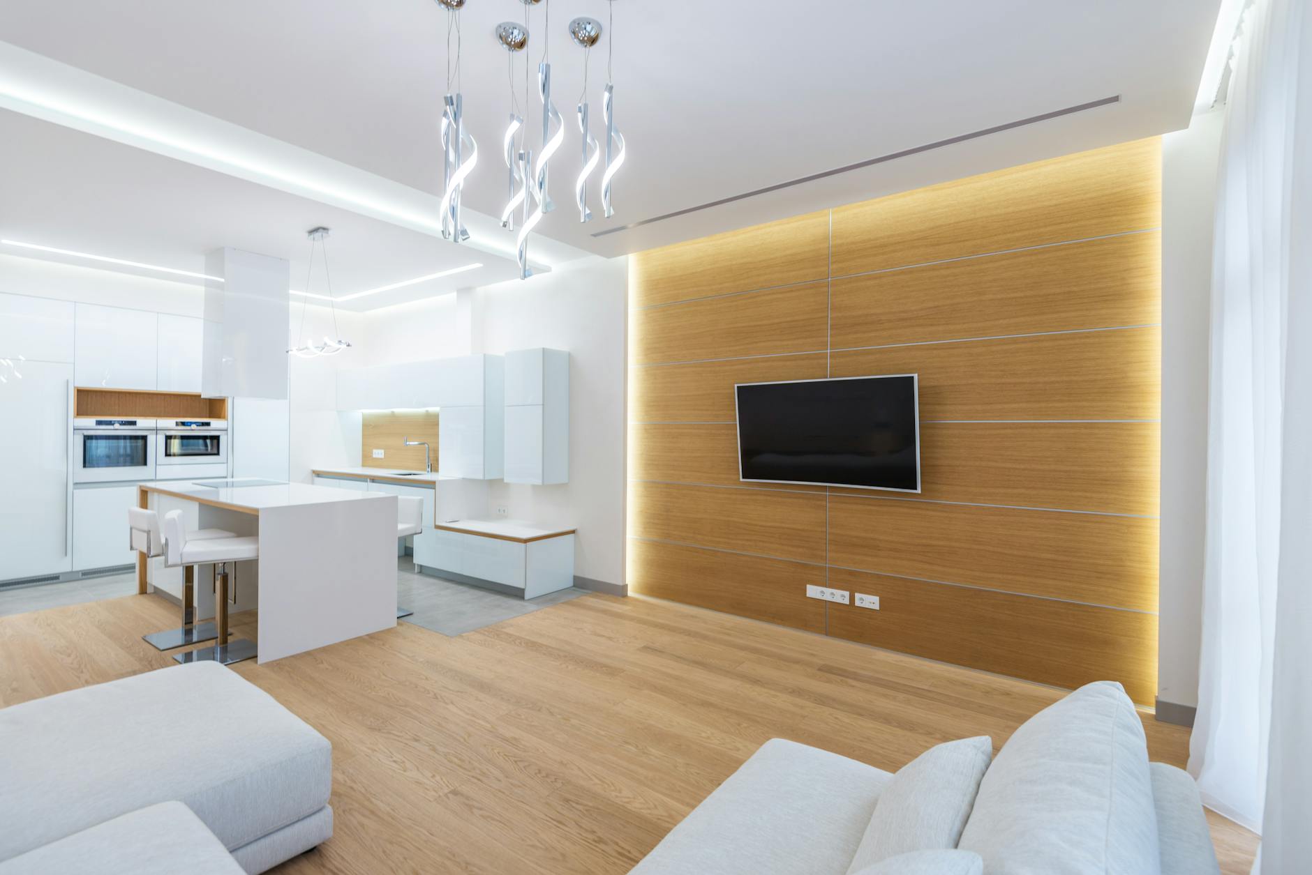 Nowoczesny salon z aneksem kuchennym oświetlony lampami LED