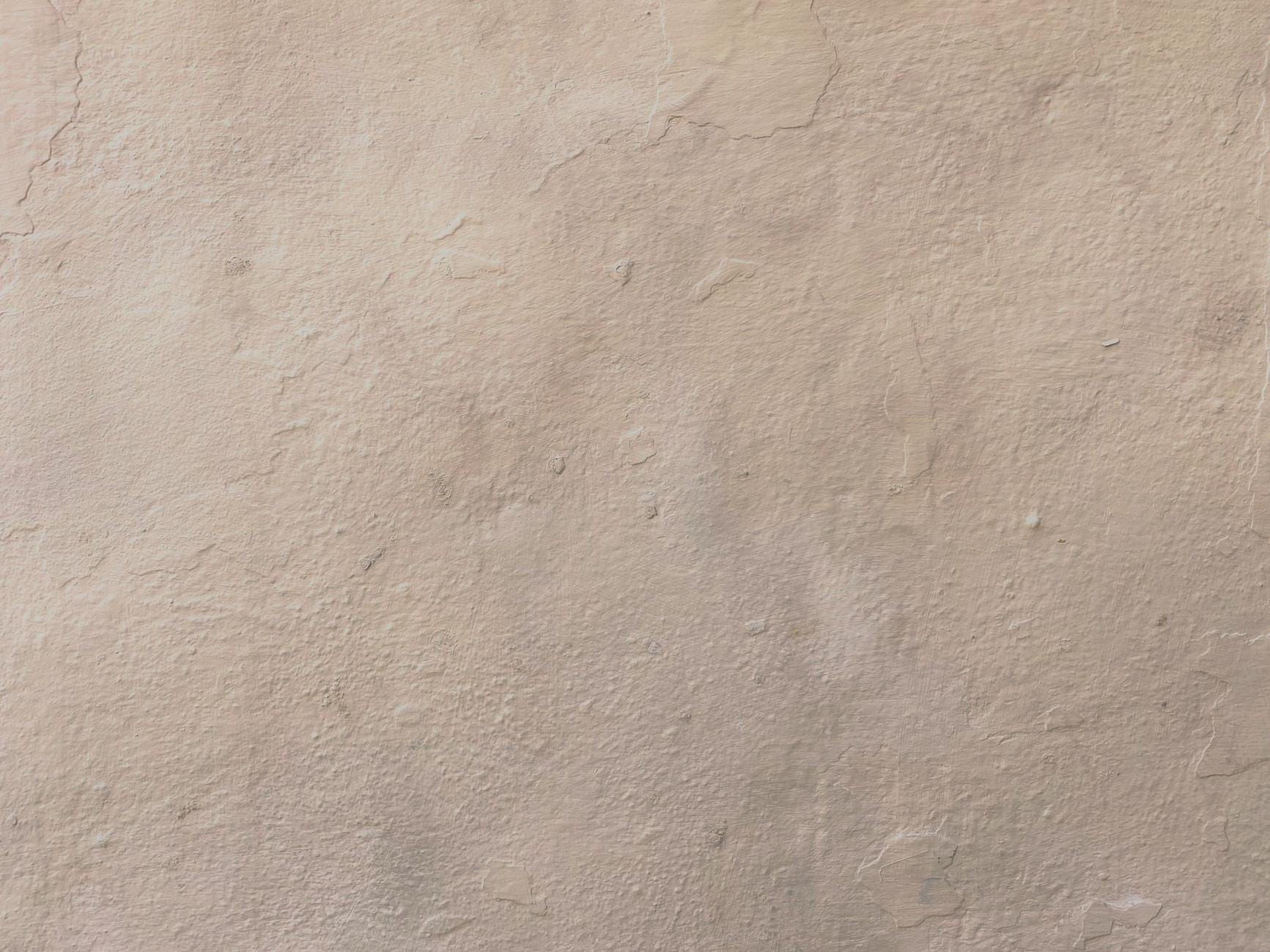 Beżowa, chropowata powierzchnia tynku gipsowego na ścianie